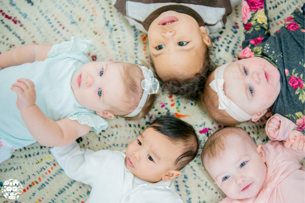 Babies lying down in a circle