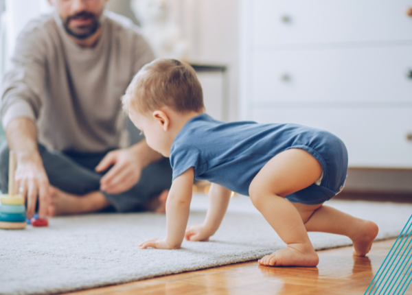 Child in blue romper crawling towards item