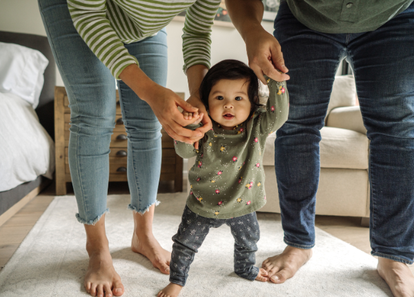 Baby being supported to walk