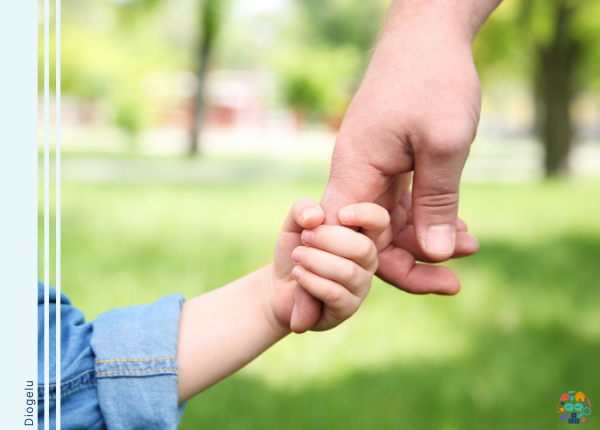 Picture show two hands, a child holding on to the finger of an adult