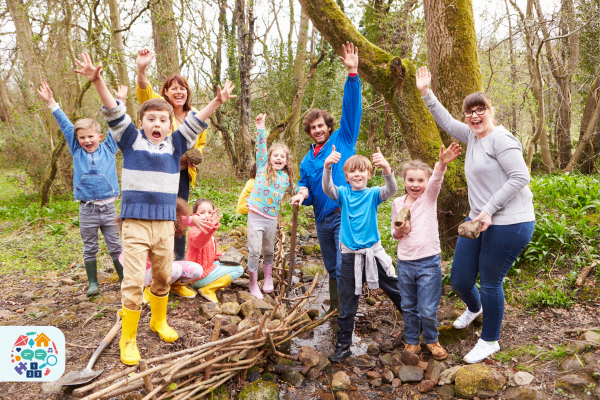 Adults and Children with hands in the air