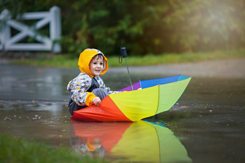 Boy-playing-in-umbrella