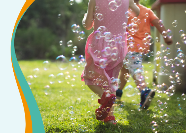 Image shows children running in bubbles