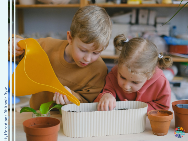 Two children watering plants
