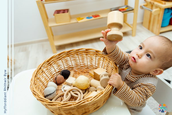Child holds up wooden toy