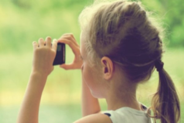 young girl using camera