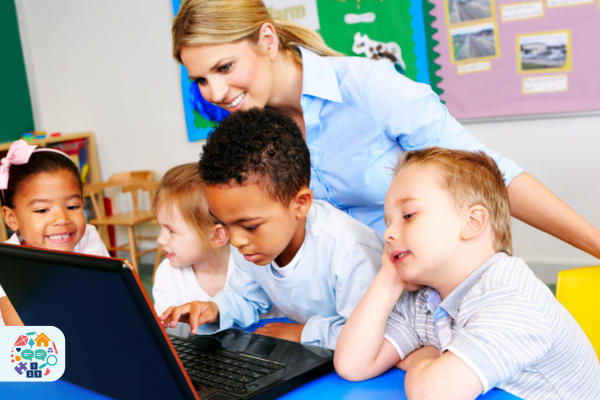 Pre-school teacher and children on laptop