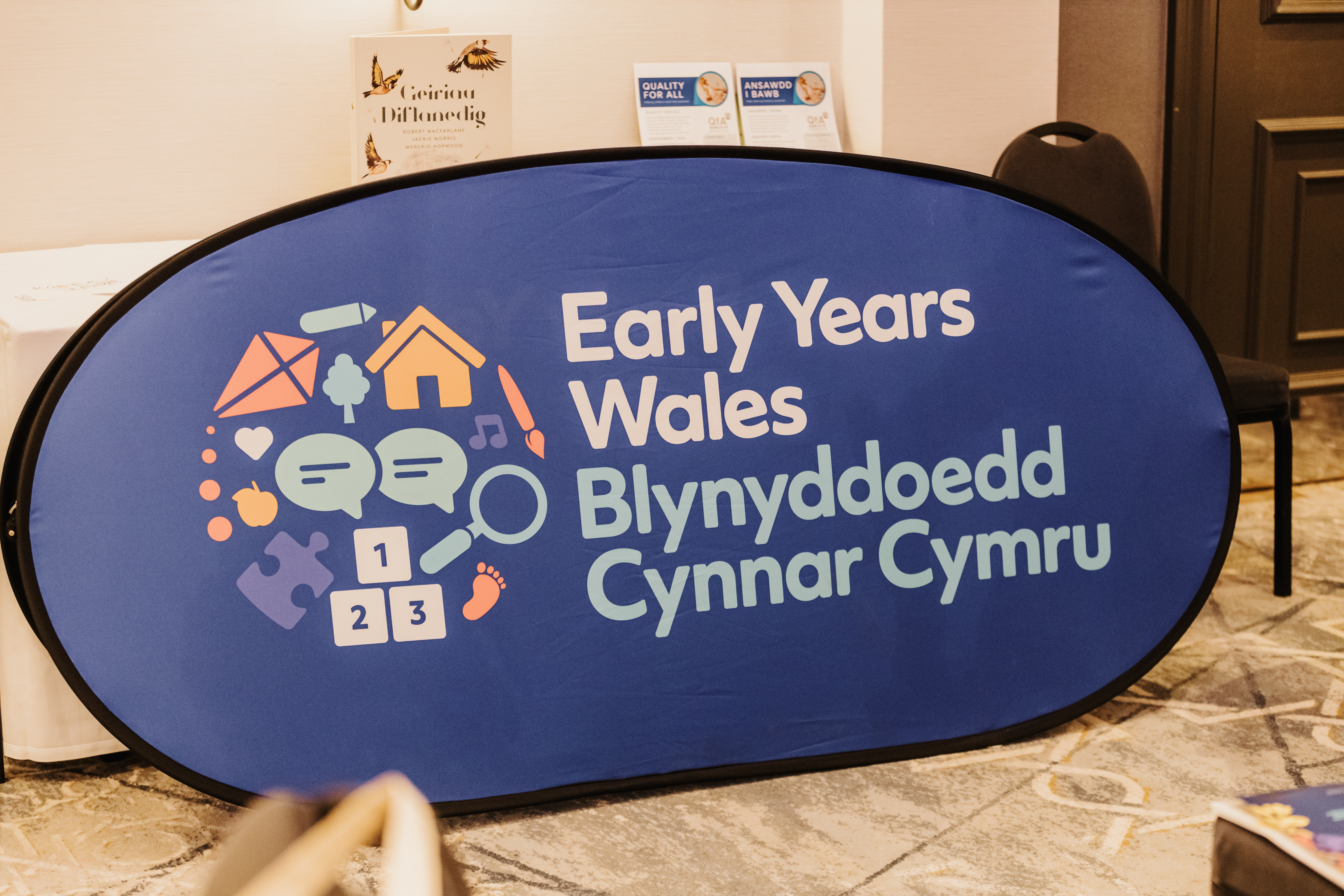 Early Years Wales logo on a big blur banner