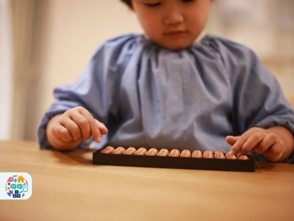 Child counting on an abacus that is flat to the table