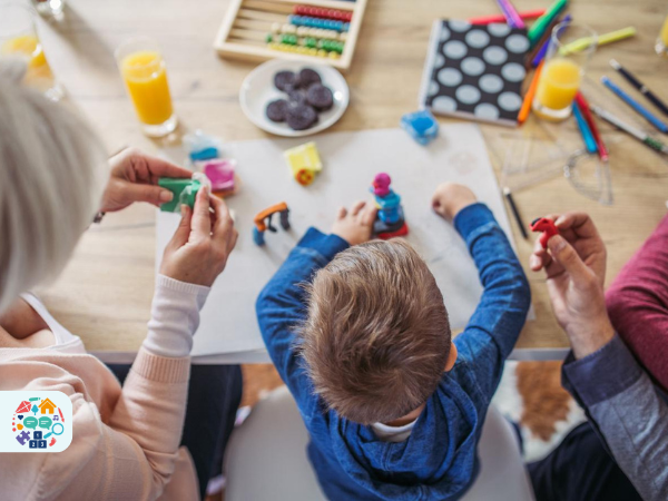 Child sat in between two adults playing with playdough