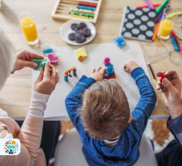 Child sat in between two adults playing with playdough