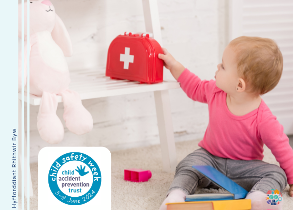 Baby reaches for a toy first aid kit