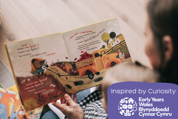 Adult reads foreign language book with child