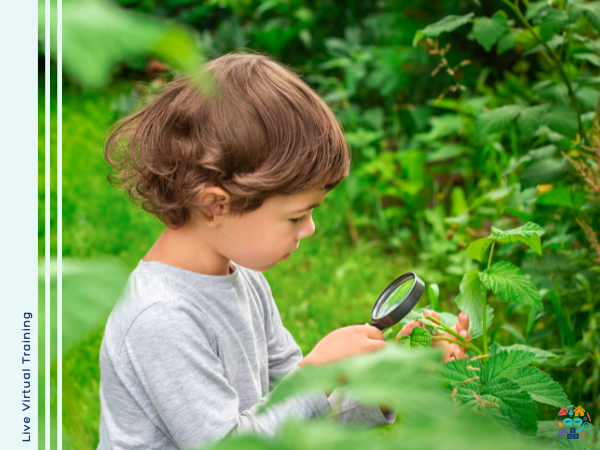 Child looking at a leaf through a magnifyer