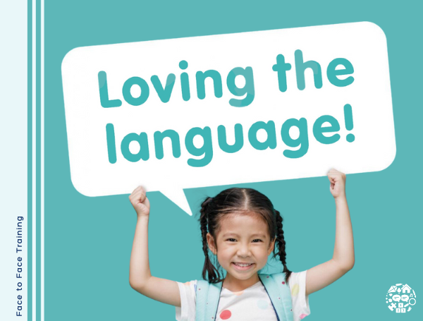 Girl holding up sign that reads "Loving the Language"