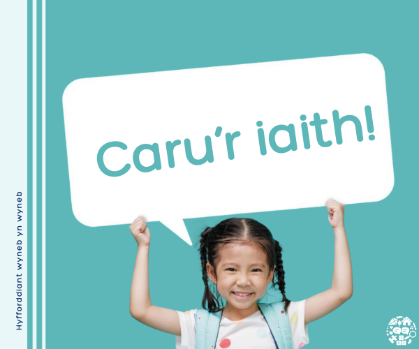 Girl holding sign that reads Caru'r iaith