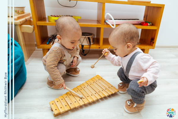 Two children play with a xylophone