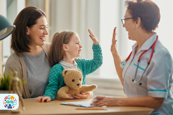 Image of child sitting on adult's lap high fiving a medical professional
