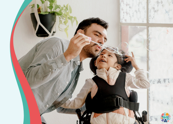 Early Years Wales Member Roadshow A child sat in an adults lap, they are smiling at each other