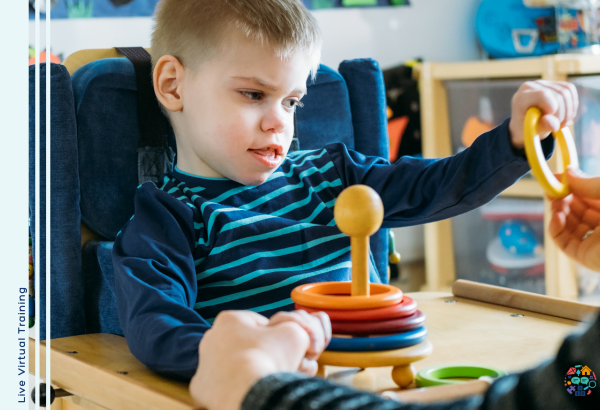 Child wearing a navy and blue striped shirt is playing with a set of wooden rings