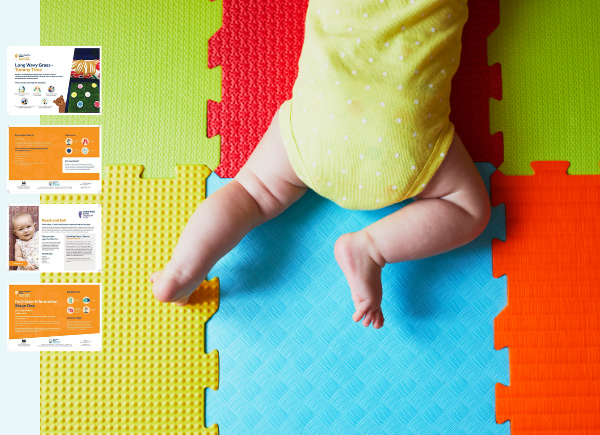 Baby in a yellow and white polka dot babygrow doing tummy time on colourful mats