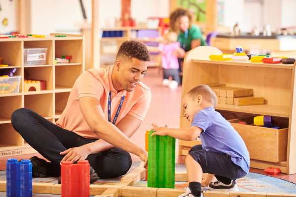 Nursery Assisstant plays with a child