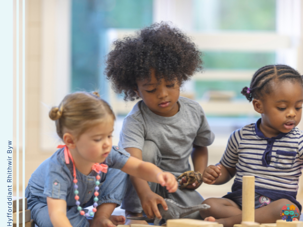 Three children play with blocks
