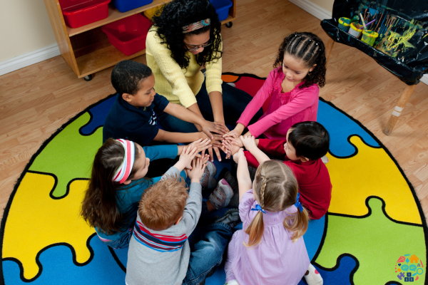 Adult sitting with children in a circle