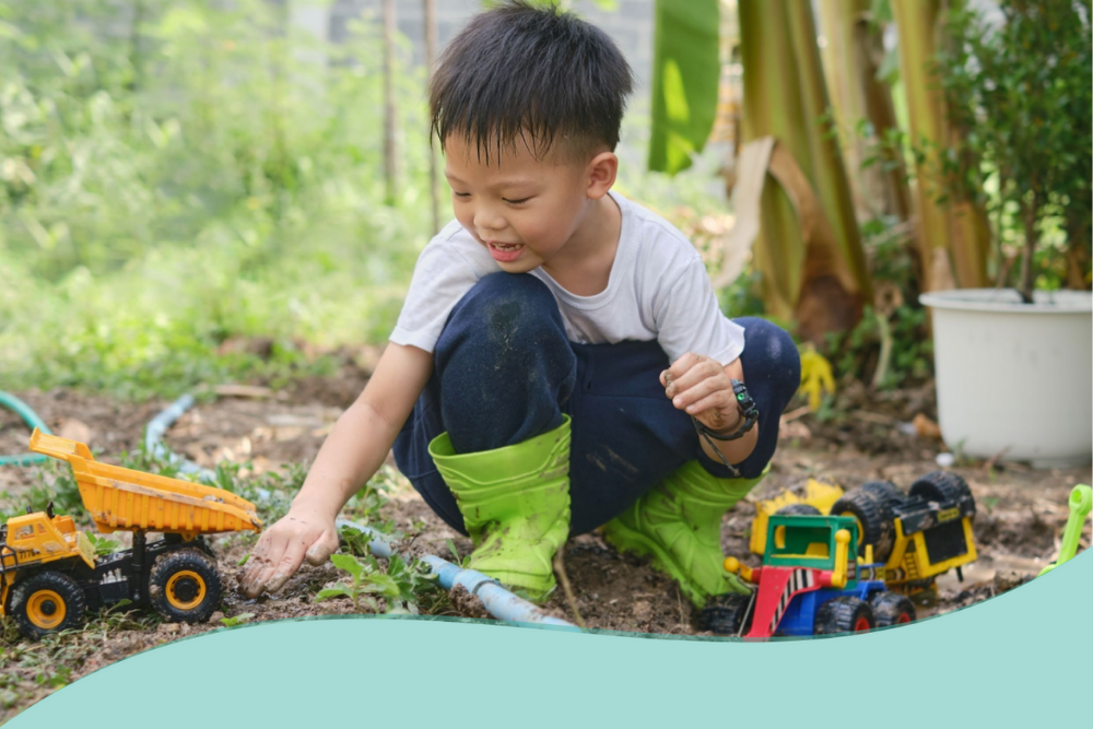 Image of a child playing in the mud with toy diggers