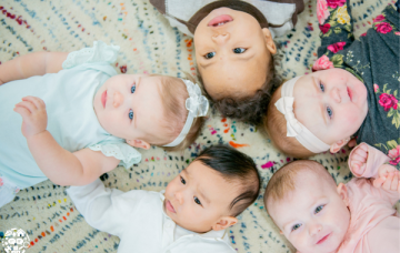 Babies lying down in a circle