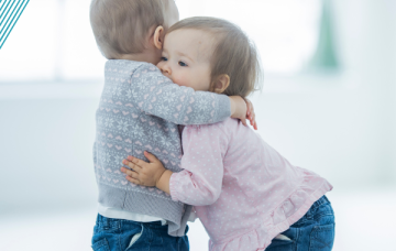 Two toddlers hugging
