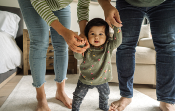 Baby being supported to walk