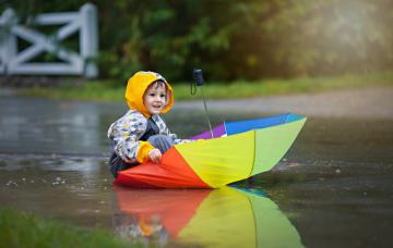 Boy-playing-in-umbrella