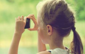 young girl using camera