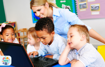 Pre-school teacher and children on laptop