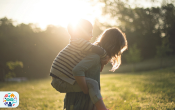 Adult giving child a piggy back