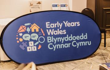 Early Years Wales logo on a big blur banner