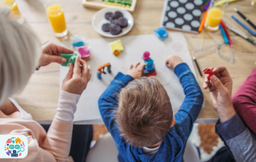 Child sat in between two adults playing with playdough