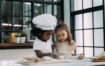 picture is of two little girls baking together