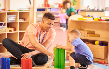 Nursery Assisstant plays with a child