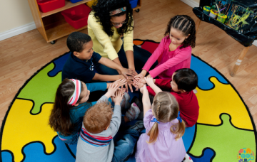 Adult sitting with children in a circle