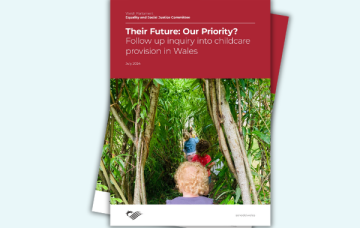 The front page of the report shows children walking through tall plants
