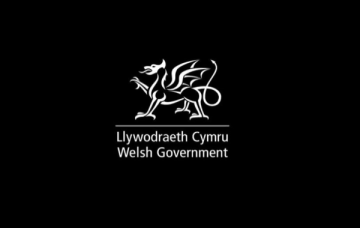 Welsh Government white on black logo