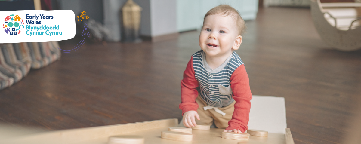Toddler crawling up wooden platform