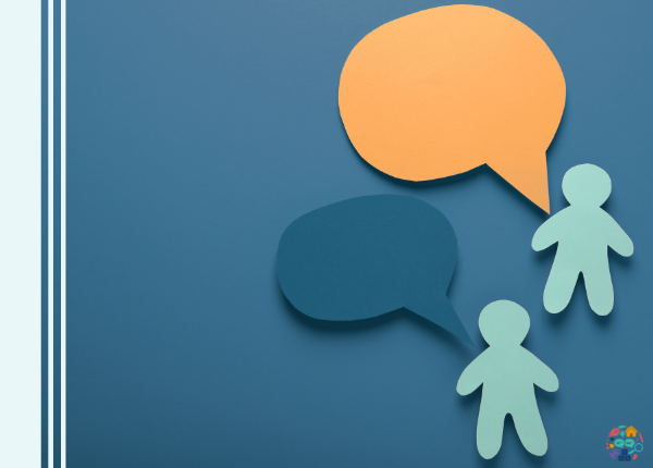 Two pieces of paper cut into the shapes of people with two conversation bubbles