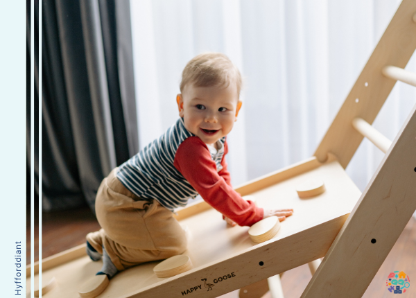 Toddler crawling on wooden climbing frame