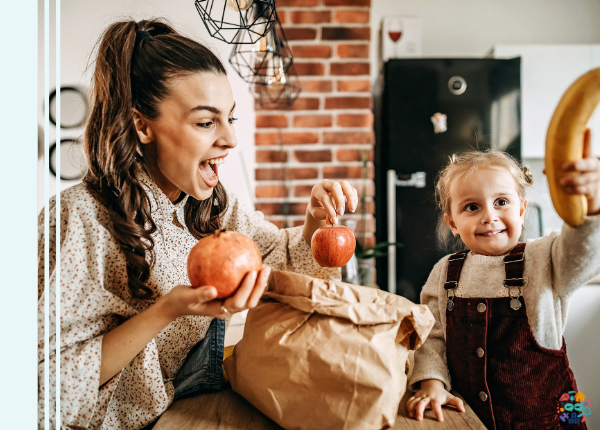 Adult and child holding various fruit