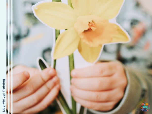 Child holding up a picture of a daffodil